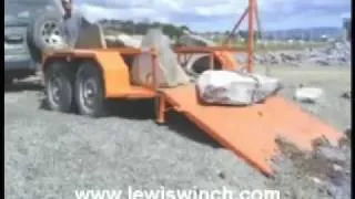 Lewis Winch, a portable chainsaw winch easily loads large rocks onto trailer.