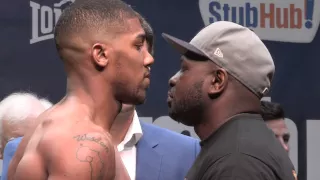 Kevin Johnson puts his hand on Anthony Joshua's chest to check his heartrate ahead of their fight
