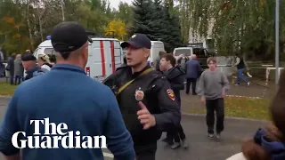 Children evacuate from Russian school after deadly shooting