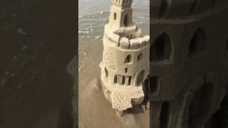 sand castle destruction by tide and waves