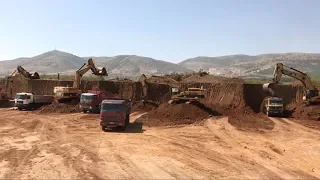 Three Caterpillar 365C Excavators And One Caterpillar 245 Loading Trucks