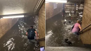 Commuters wade through water as Storm Elsa floods New York subway stations