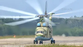 Huge Mil Mi-26 helicopter during takeoff, then pilot waves for a greeting