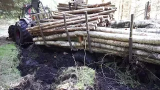 Valtra forestry tractor stuck in mud, wet spring forest