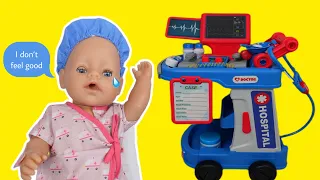 Baby Born doll is sick and goes to the doll Hospital Doctor Toy play set cart