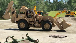 High speed HMEE military backhoes perform with JCB Dancing Diggers