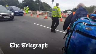 Protesters allowed to walk in front of cars and block M25 by police