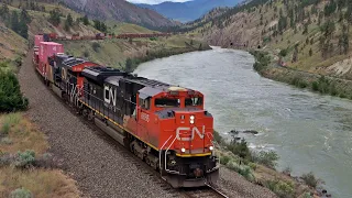Big Long CN Freights Following Alongside The Thompson River, Thru Tunnels And Slide Sheds - CANADA