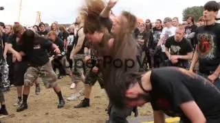 Mid Panning Shot, Heavy metal fans mosh, head bang and da...