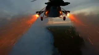 Ukraine Mi-8 attack helicopter firing rockets and decoy flares on Russian positions.