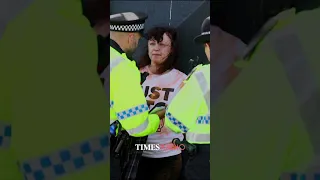 Just Stop Oil protesters set off an orange flare at the British Open