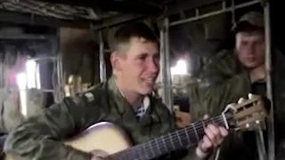 Russian soldier sings to the guitar: "For what we drink"