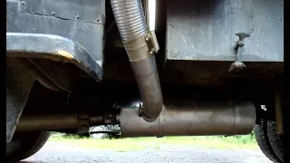 Installing a muffler on a dump truck