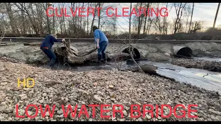 unclogging low water bridge. culverts clogged. 12/18/22