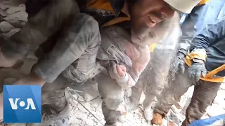 Syrian Rescue Workers Pull a Child from Rubble after Earthquake | VOA News