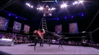 Sonny Kiss splashes Joey Janela off ladder through table