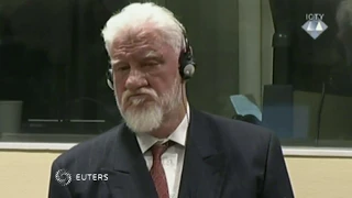 Bosnia war criminal dies after taking poison in court