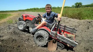 Hudson works on the farm digging dirt and moving hay | Tractors for kids