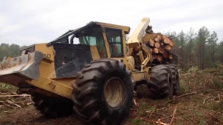 A loaded Peterbilt log truck in the ditch & our Tigercat 635D