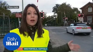 Audi driver jumps red light at level crossing on live news Suffolk