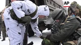 Ukrainian soldiers take up duties at Donetsk Airport, separatists give them Christmas presents