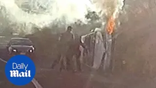 Incredible moment cops pull man out of his burning car