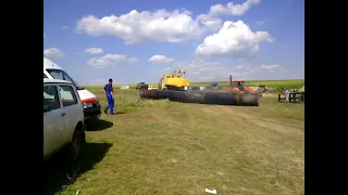 Russian KRAZ truck crane pulls a gas pipeline