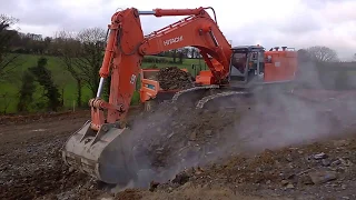 Hitachi 870 excavator loading dumpers on a road construction site #1