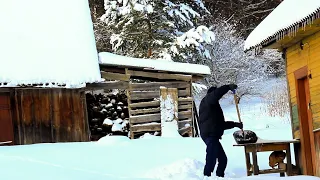 Simple rural life near the forest in winter. Restoration of a log house.
