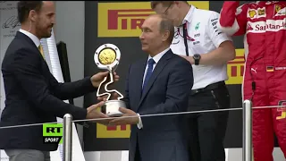 Lewis hamilton does which noone will ever dare,splashes champagne on Putin