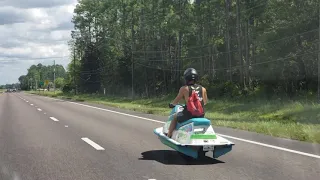Florida man riding jet Ski/scooter down roadway