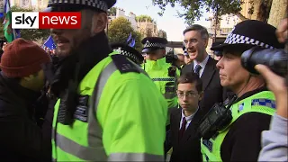 Protesters heckle Jacob Rees-Mogg and young son