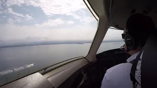Landing at KNEW in a Challenger 300 cockpit view.