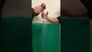 World's fastest spinning golf ball in slow motion dropped in tube of water.