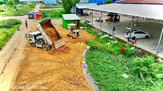 Experts are pushing soil from the sidewalk and pouring soil rock on the forest & 5 ton trucks