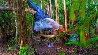 camping in heavy rain, making a tree house out of plastic wrap and using a homemade wood stove