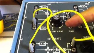 Solving the differential equation of a damped oscillator using a vintage analog AMF665D computer