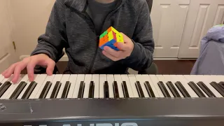 Solving a Rubik's Cube While Playing Piano