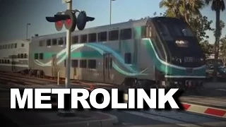 Metrolink train honks its horn as it rolls into railroad station in Oceanside