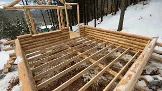 Floor joist install- Butt and Pass Log Cabin Build