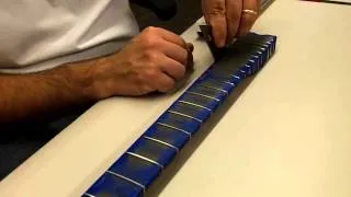 Repairing uneven frets: Leveling frets using a sanding beam