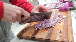 horizontal swipes on onions with Chinese cleaver