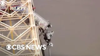 Driver rescued after crashed semi dangles off Louisville bridge: "She was praying"