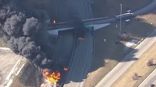 Flames pour from manhole covers on I-94 during tanker fire