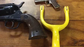 Guns that were  marketed to kids, Daisy 179 Pistol, vintage Cap Gun and a Slingshot