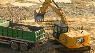 Cat 323GC And Cat 320 Excavator Digging Stone Loading Into Dump Truck