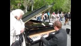 Colin Huggins plays piano in Washington Square Park as Doris watches.