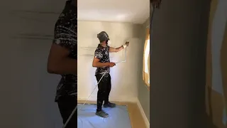 Painting wall with spray gun