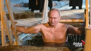Putin strips down for icy dip in frozen lake to mark Orthodox Epiphany
