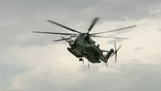 U.S. Marines use CH-53E Super Stallion to perform External lift of Harrier Jet.